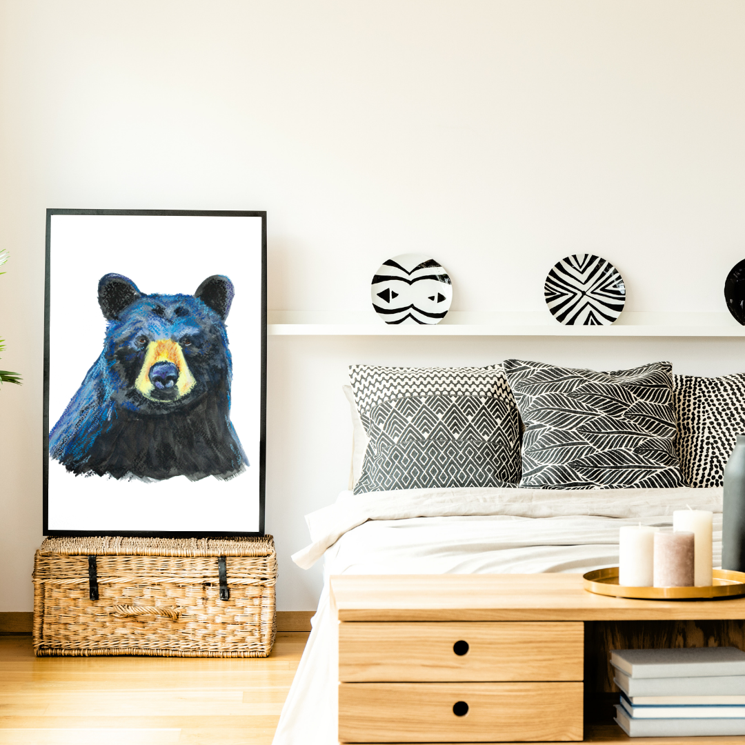 Room interior with a bear painting on the wall, bed with patterned pillows, and wooden nightstand.