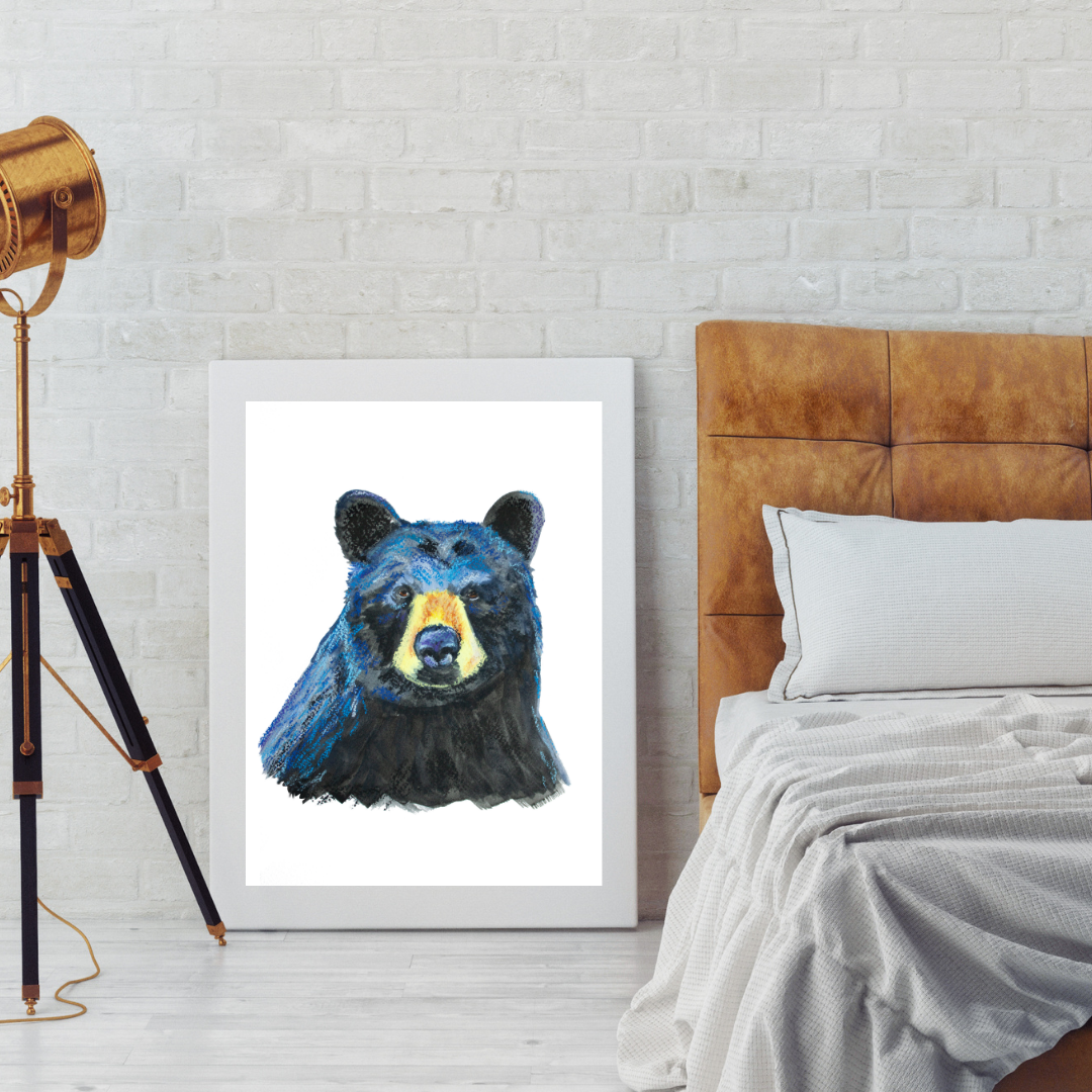 Framed artwork of a bear head on a wall next to a bed with a brown headboard.